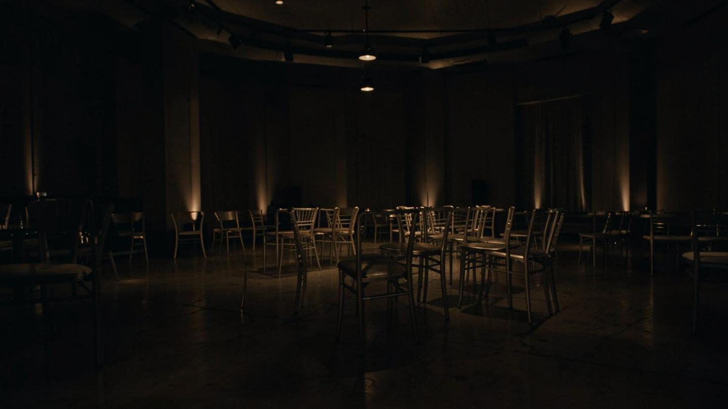 A quiet, dimly lit empty event room
